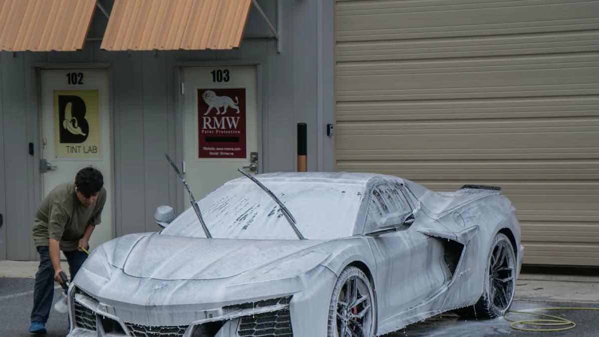 Snow-foam wash covering a luxury sports car in South Florida